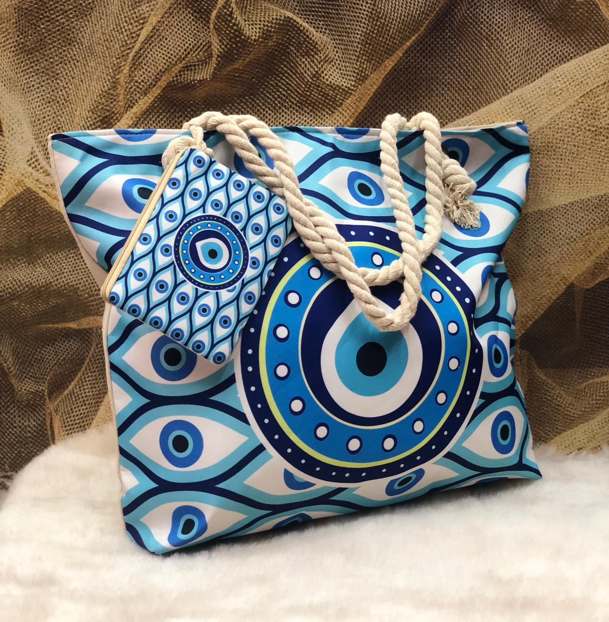 Blue and white patterned bag with rope handles on a textured background